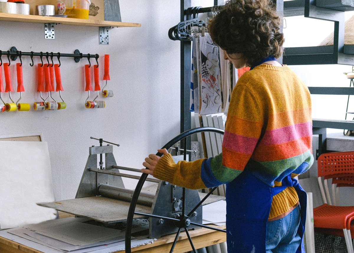 An operator working at a garment printing bench