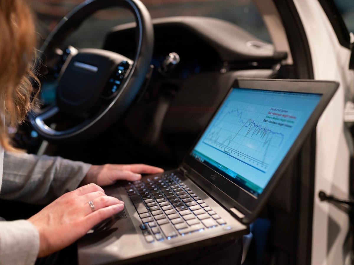 An engineer using a laptop to check equipment